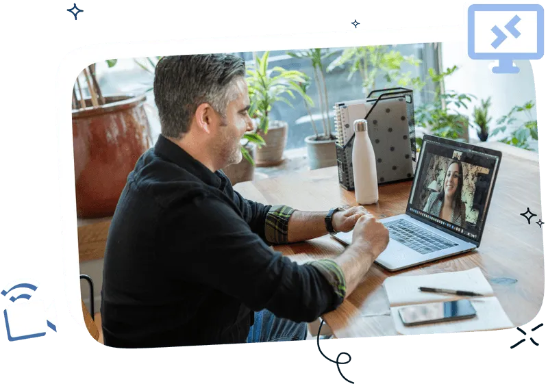 A man sitting in front of a laptop talking to a colleague from abroad